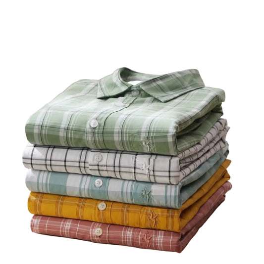 Stack of plaid shirts with '#CHECKS' text on a light background